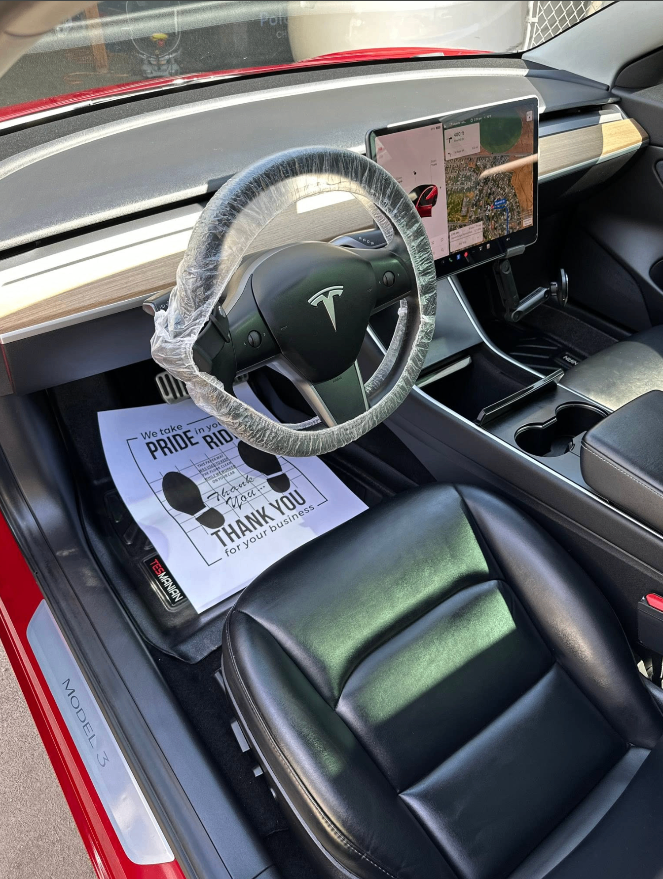 Tesla interior detailed with clean leather and protected steering wheel